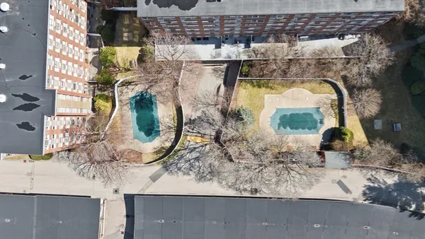 an aerial view of multiple houses with yard