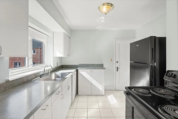 a kitchen with a sink stove and cabinets