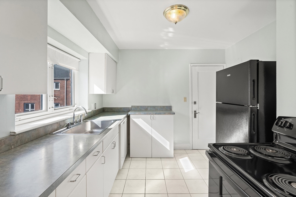 130 Boylston Street, Unit 3 Newton, MA 02467 - Photo 3 of 24 a kitchen with a sink appliances and cabinets