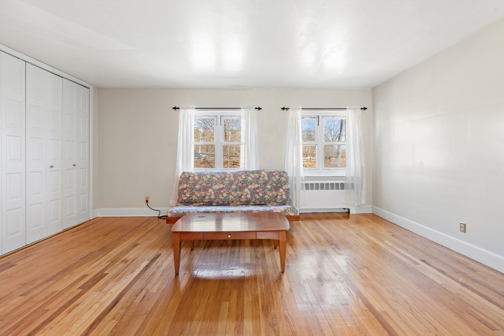 130 Boylston Street, Unit 3 Newton, MA 02467 - Photo 8 of 24 a bedroom with wooden floor and windows