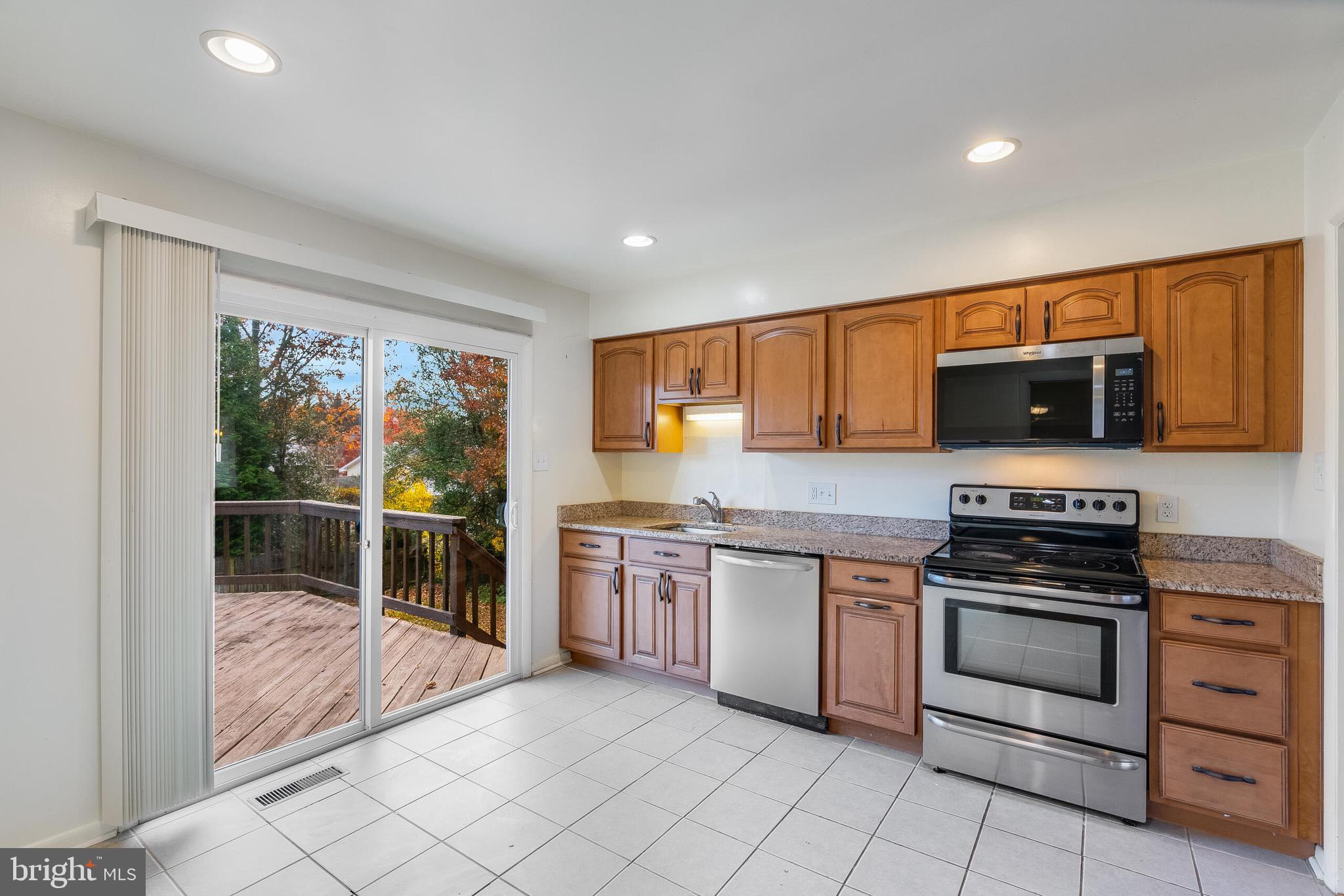 6503 Machodoc Court Falls Church, VA 22043 - Photo 12 of 34 a kitchen with stainless steel appliances granite countertop a stove and a sink
