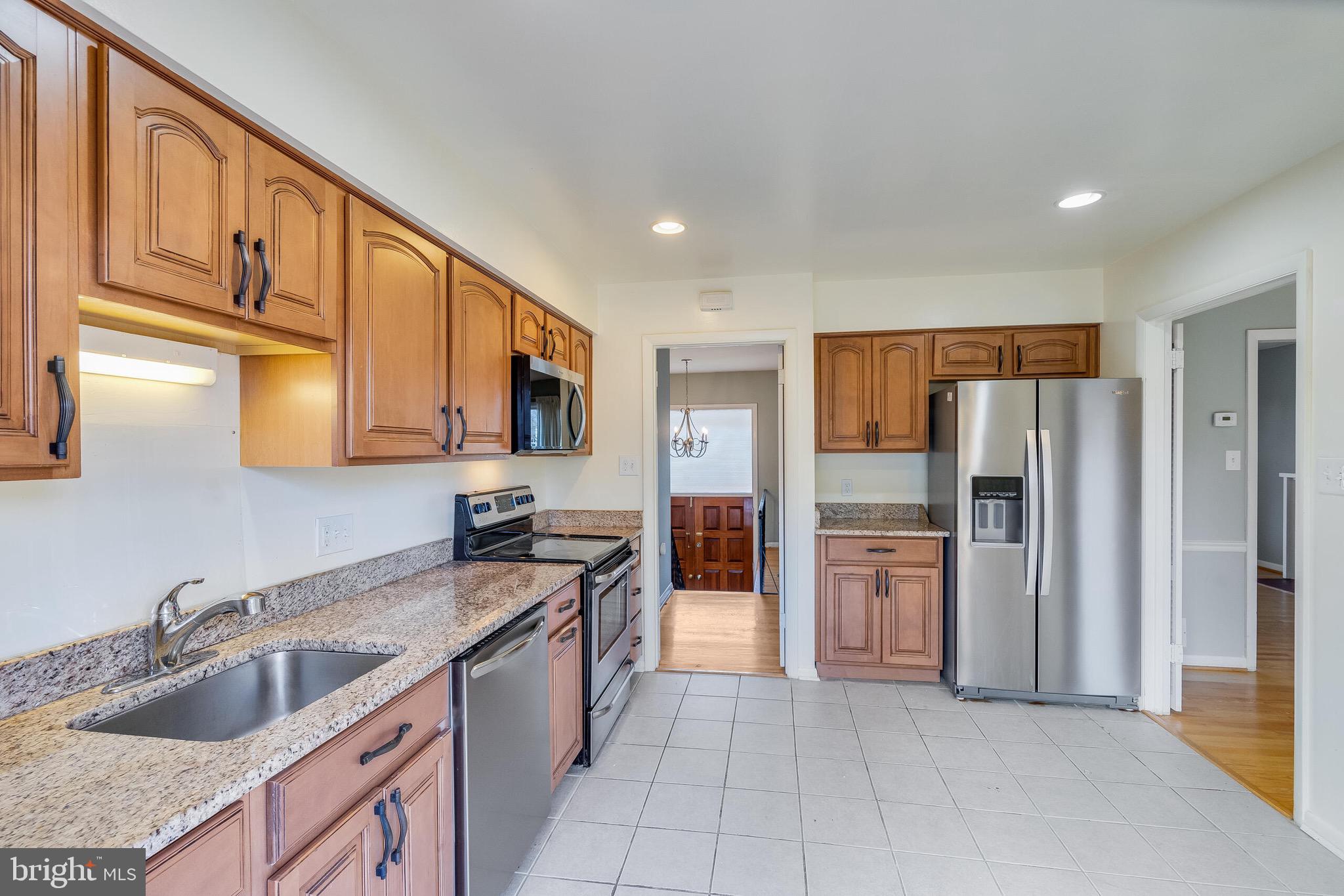 6503 Machodoc Court Falls Church, VA 22043 - Photo 14 of 34 a kitchen with stainless steel appliances granite countertop a refrigerator and a sink