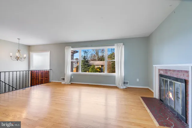 a view of an empty room with glass door and balcony