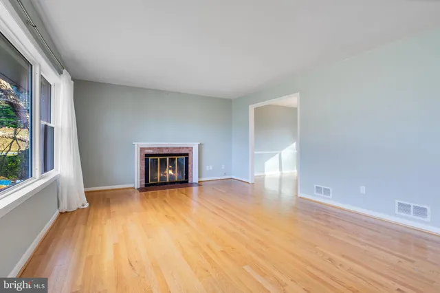 a view of a room with wooden floor and a window