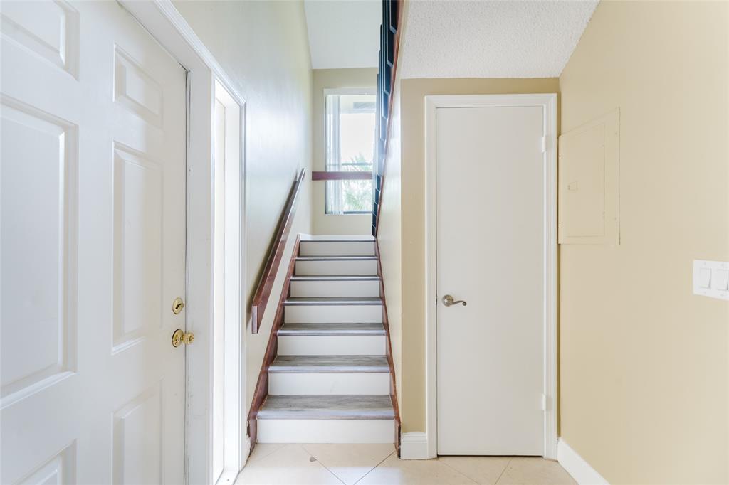 Undisclosed Address Boca Raton, FL 33428 - Photo 19 of 36 a view of a hallway with wooden floor and entryway