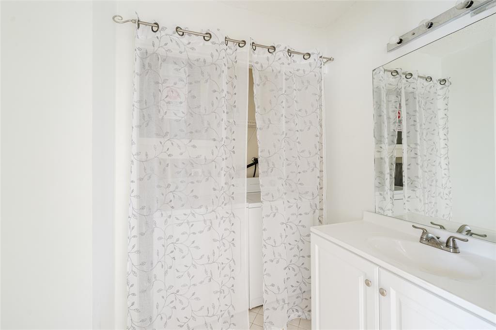 Undisclosed Address Boca Raton, FL 33428 - Photo 29 of 36 a bathroom with a sink a mirror a shower and vanity