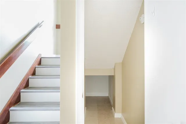 a view of staircase with white walls