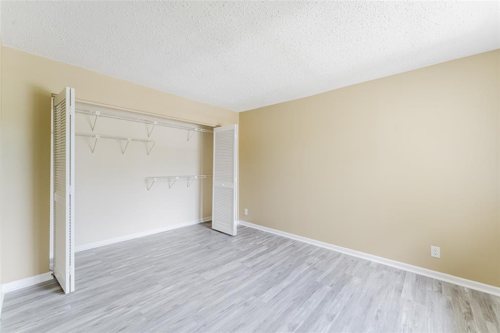 Undisclosed Address Boca Raton, FL 33428 - Photo 34 of 36 a view of an empty room with wooden floor