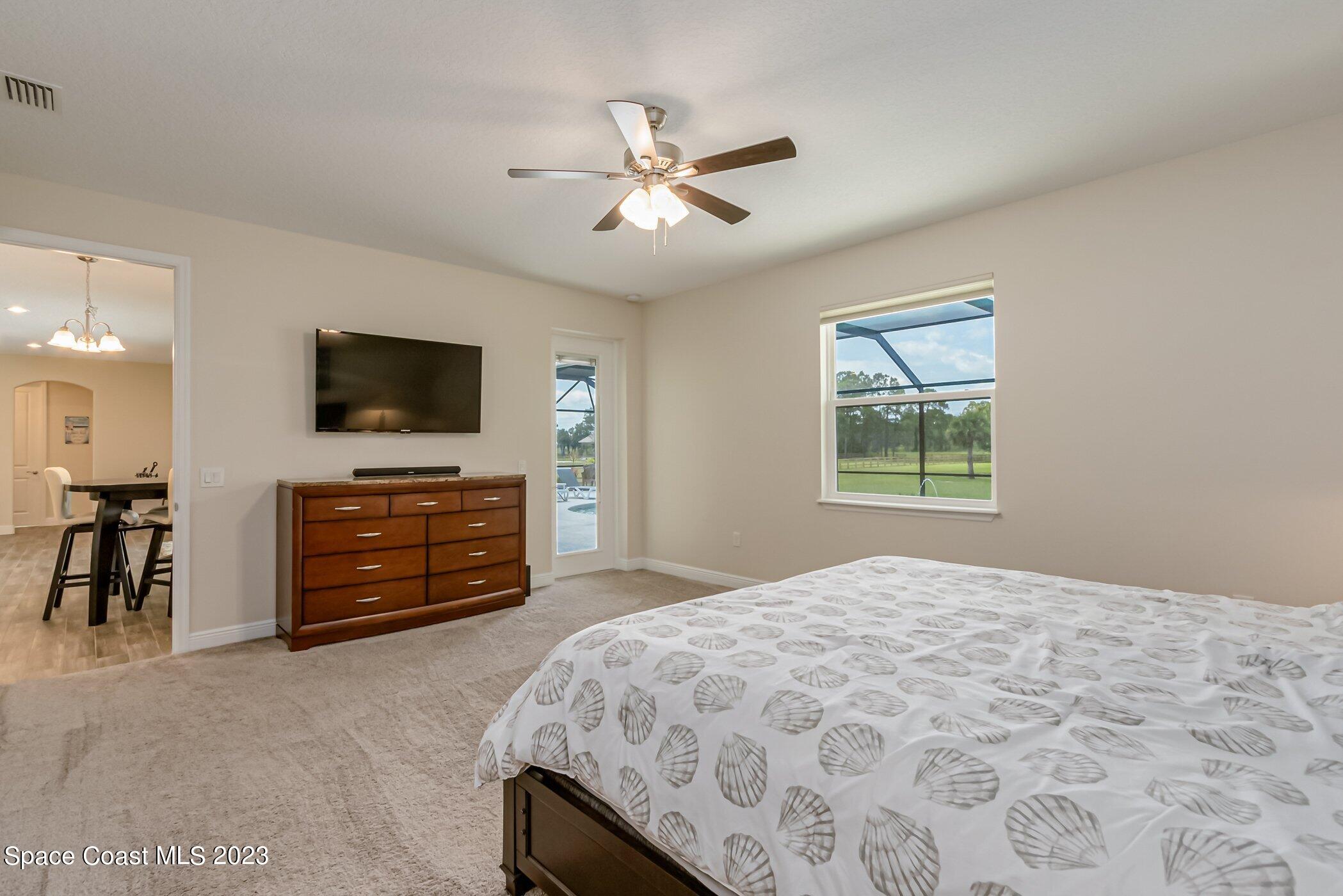 235 Deer Run Road Palm Bay, FL 32909 - Photo 13 of 49 235-Deer-Run primary bedroom towards din