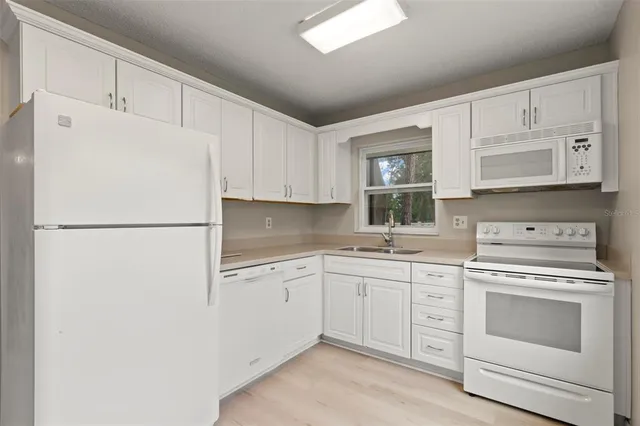 a kitchen with a sink and a refrigerator