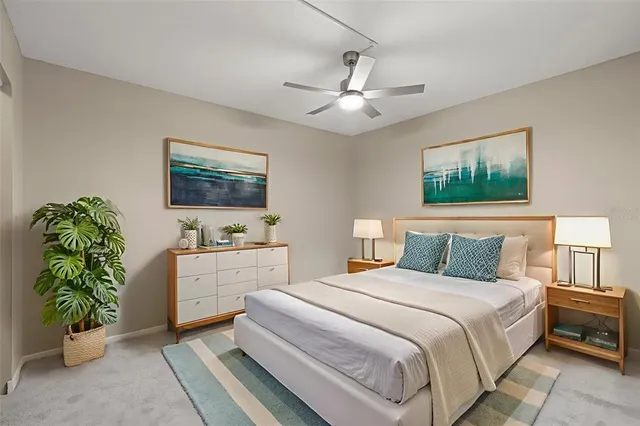 an empty room with a window and ceiling fan