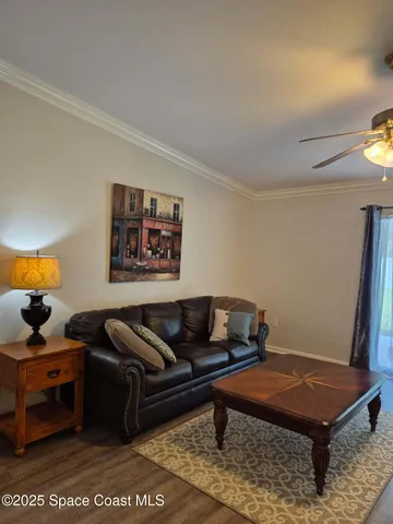 a living room with furniture rug and lamp