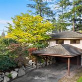 a view of a house with a table and chair under an umbrella