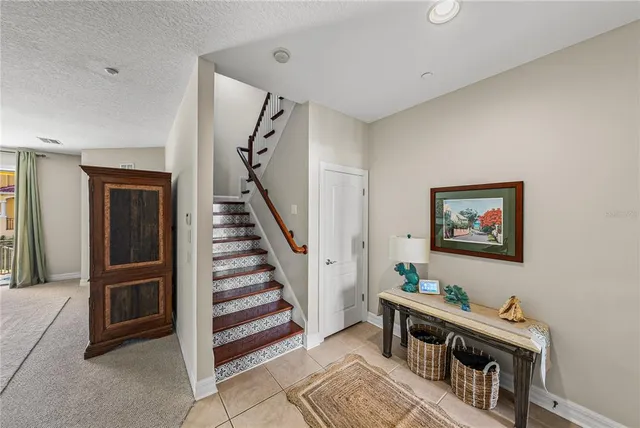 a living room with furniture a rug and a chandelier