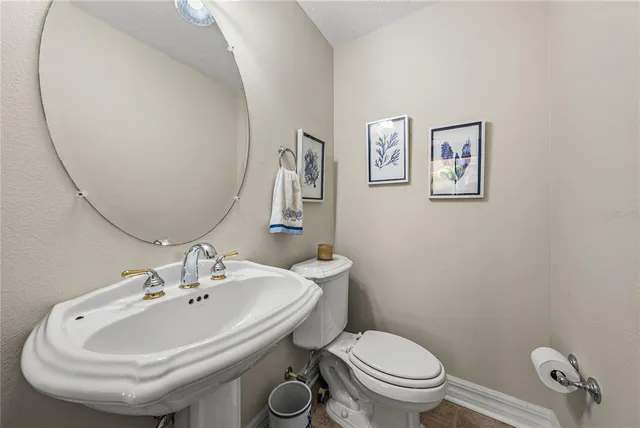 a dining room with furniture a chandelier and wooden floor