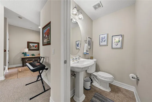 a dining room with furniture a chandelier and wooden floor