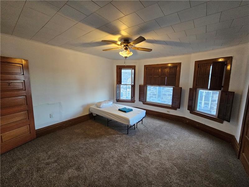 325 Adams Street Rochester, PA 15074 - Photo 9 of 14 an empty room with chandelier fan and windows