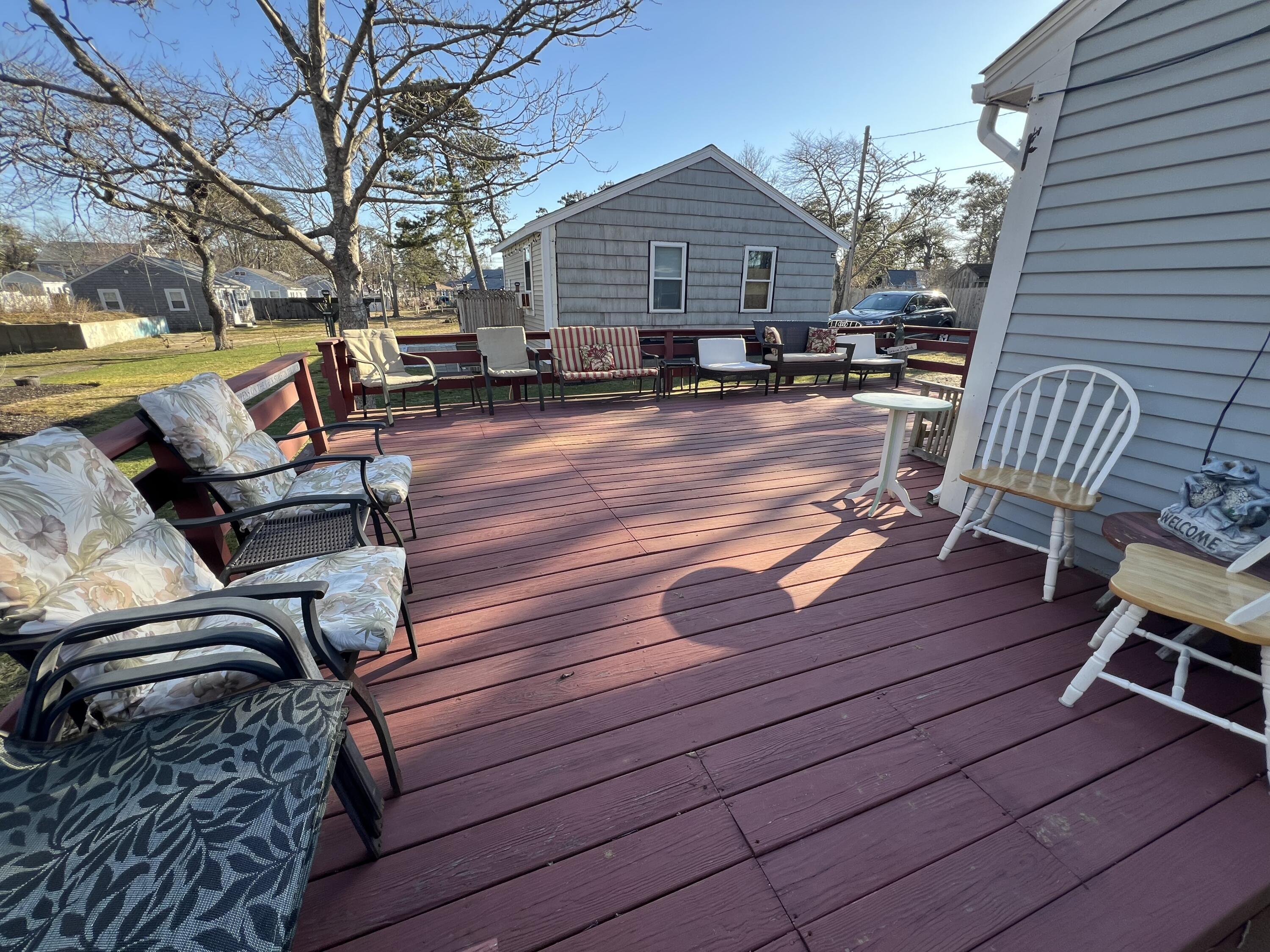 7 A Toms Path Dennis Port, MA 02639 - Photo 15 of 23 a patio with wooden floors and furniture