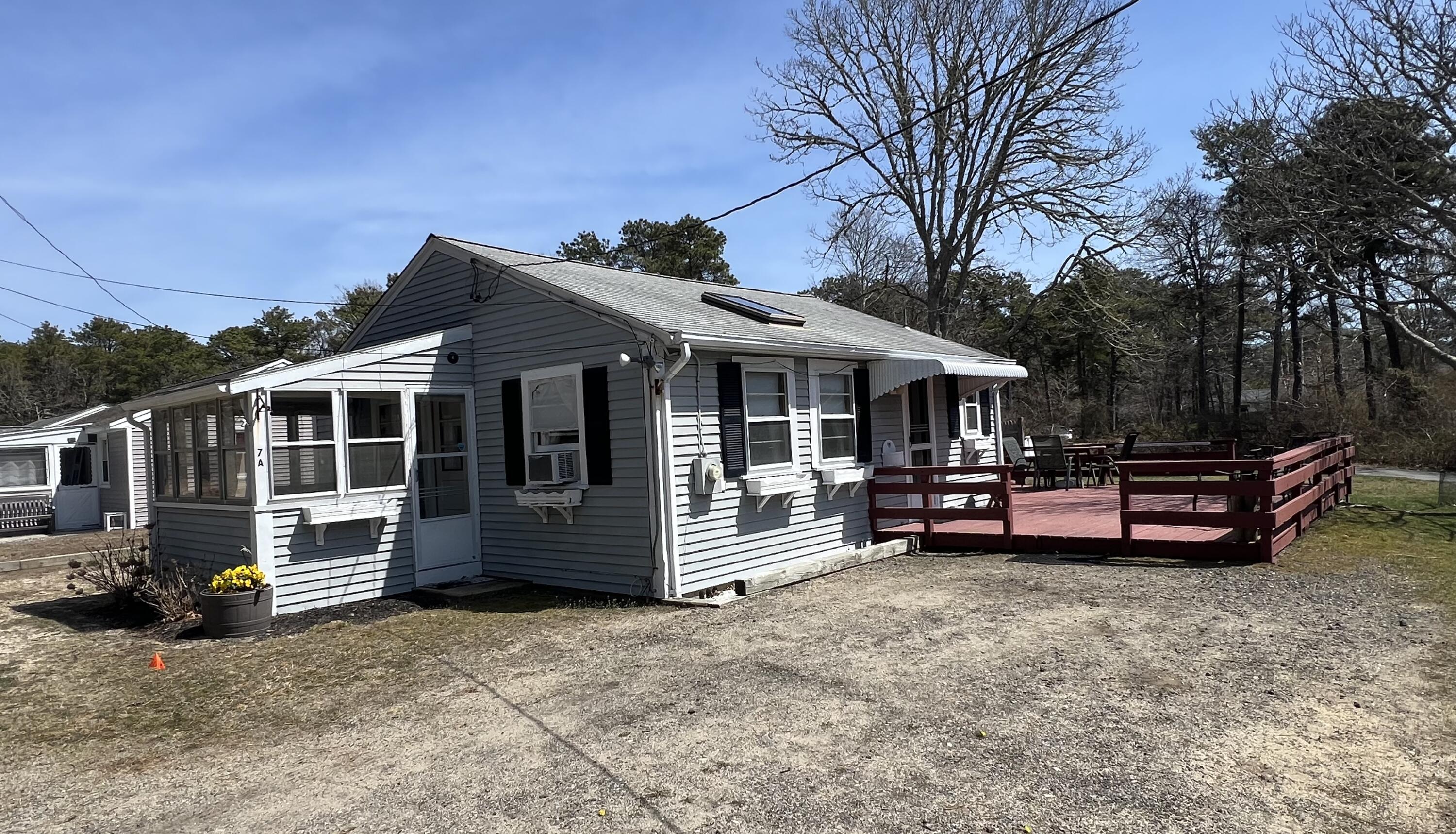 7 A Toms Path Dennis Port, MA 02639 - Photo 2 of 23 a view of a house with a barbeque and wooden fence