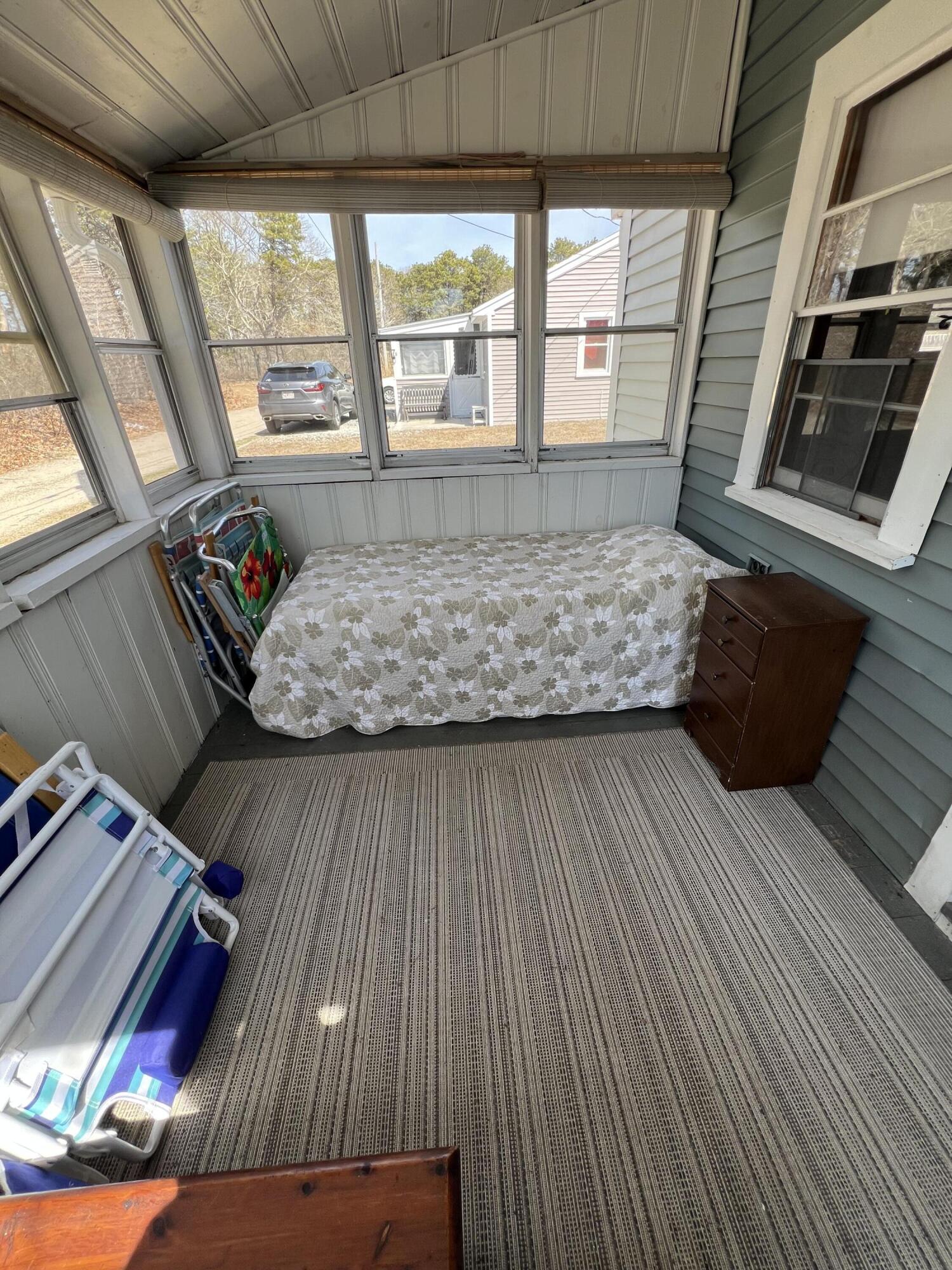 7 A Toms Path Dennis Port, MA 02639 - Photo 21 of 23 a living room with couch wooden floor and a large window