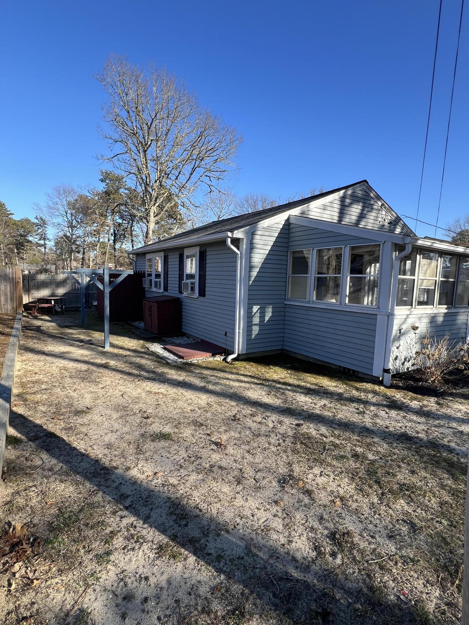 7 A Toms Path Dennis Port, MA 02639 - Photo 23 of 23 a front view of a house with a yard