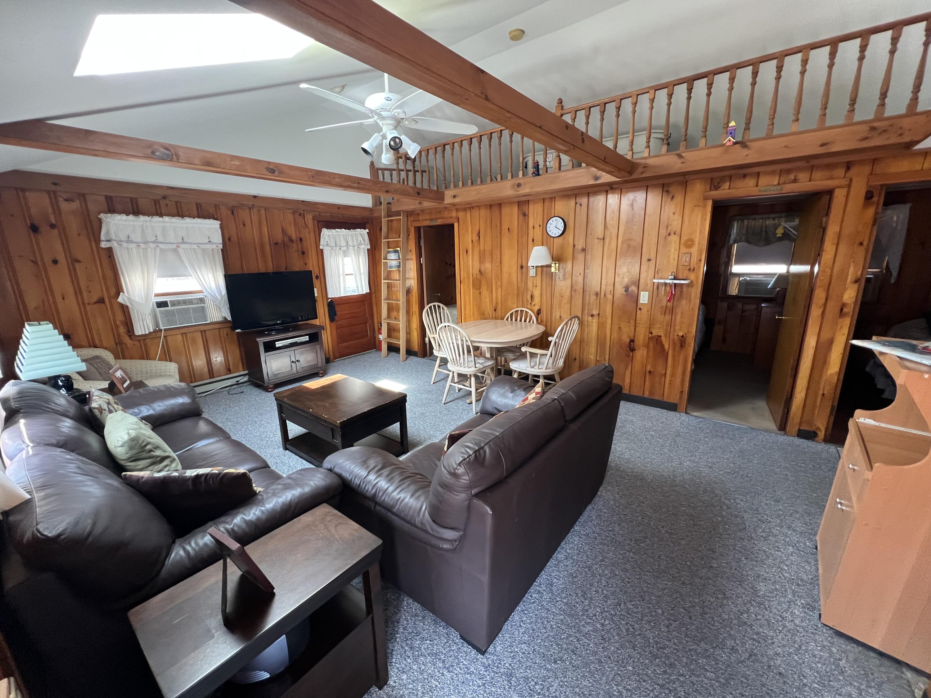 7 A Toms Path Dennis Port, MA 02639 - Photo 4 of 23 a living room with furniture a flat screen tv and a large window