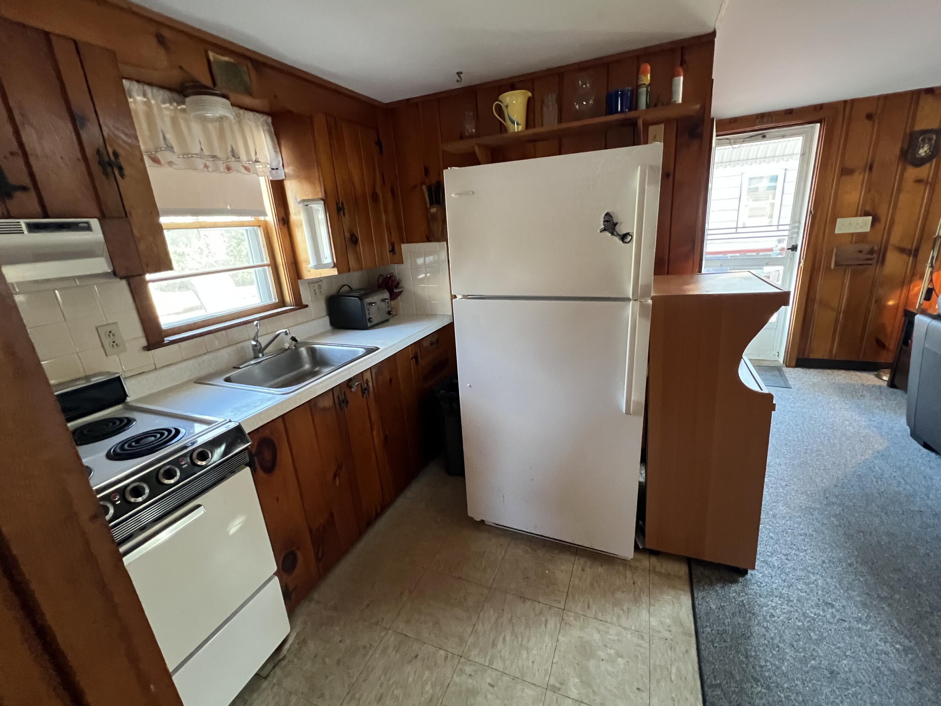 7 A Toms Path Dennis Port, MA 02639 - Photo 6 of 23 a kitchen with a refrigerator and a stove