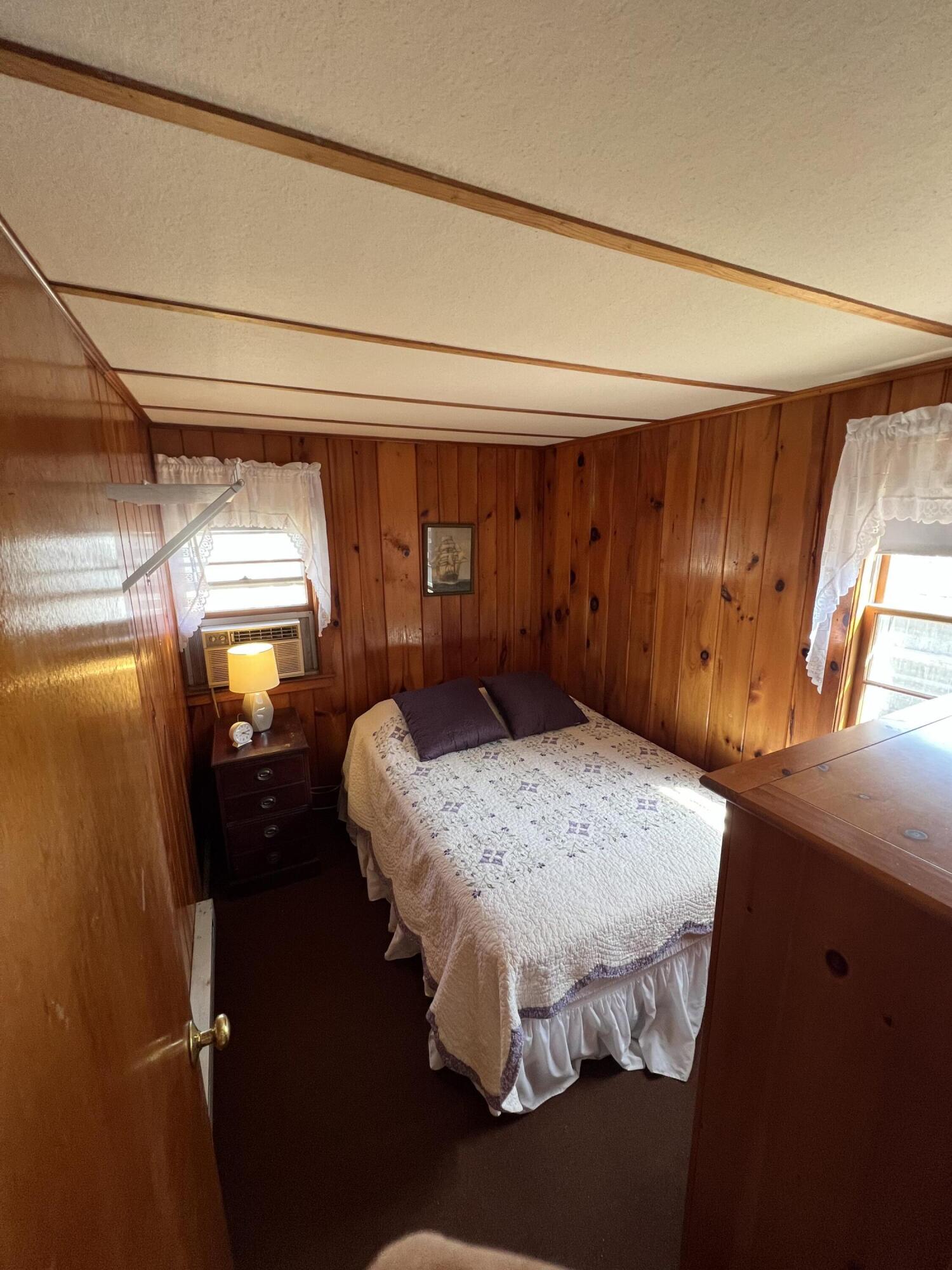 7 A Toms Path Dennis Port, MA 02639 - Photo 8 of 23 a bed sitting in a room next to a window