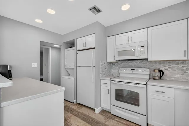 a view with dining table chairs and wooden floor