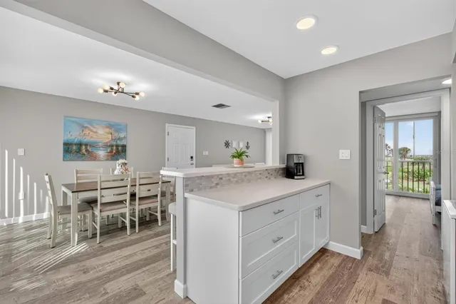 a kitchen with appliances a sink and cabinets