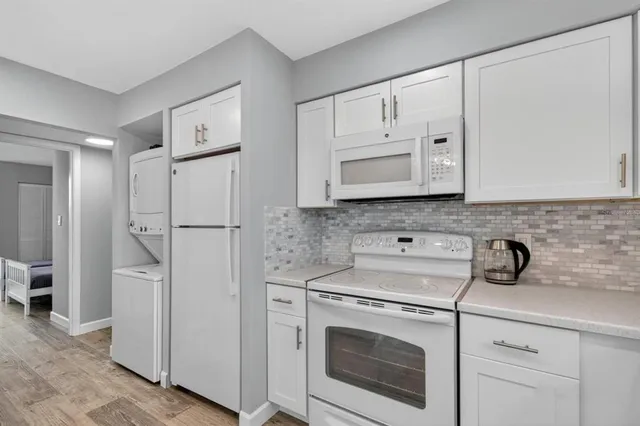 a spacious bathroom with a granite countertop sink a mirror a vanity and a shower