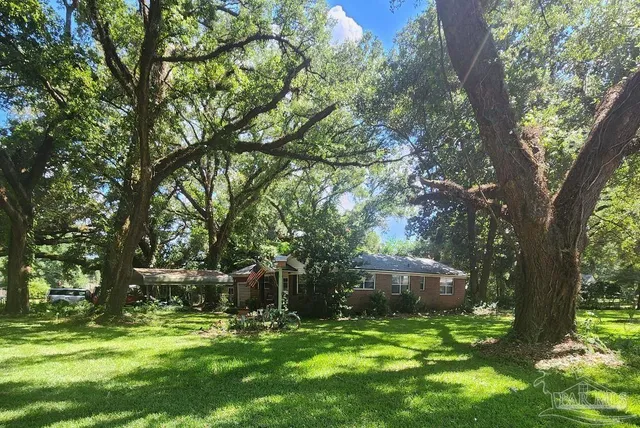 a backyard of a house with yard and outdoor seating