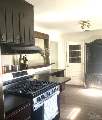 a kitchen with granite countertop a stove and a sink