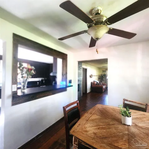 a view of a livingroom with furniture and a hallway