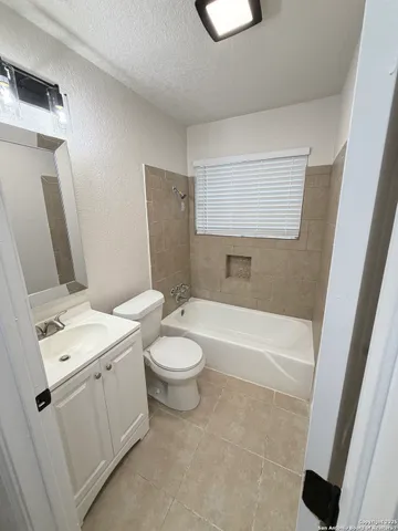a bathroom with a toilet a sink and bathtub