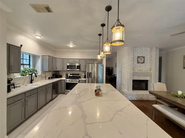a dining table with chairs and kitchen view