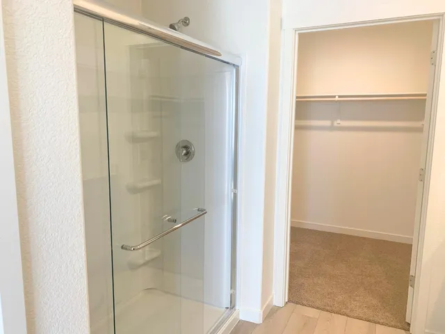 a bathroom with a glass shower door