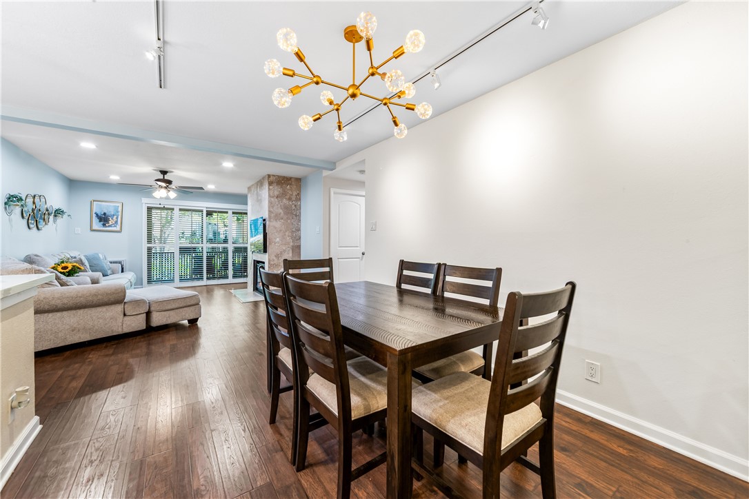 7890 East Spring Street, Unit 22F Long Beach, CA 90815 - Photo 11 of 35 a view of a dining room with furniture and wooden floor