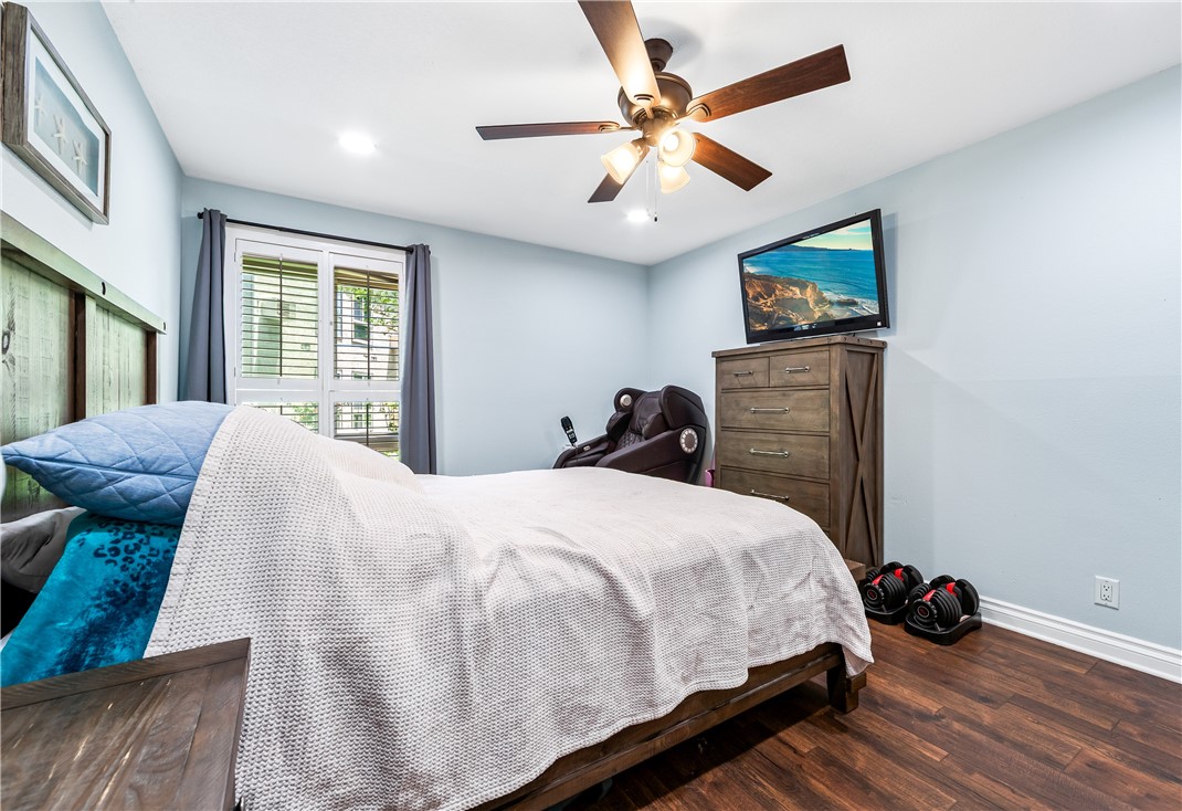 7890 East Spring Street, Unit 22F Long Beach, CA 90815 - Photo 14 of 35 a bedroom with a bed and a chandelier