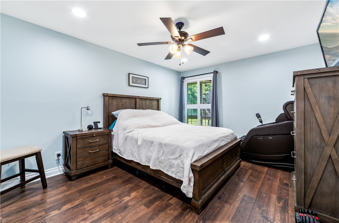 7890 East Spring Street, Unit 22F Long Beach, CA 90815 - Photo 16 of 35 a bedroom with a bed and a chandelier