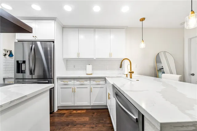 a kitchen with a sink and stainless steel appliances