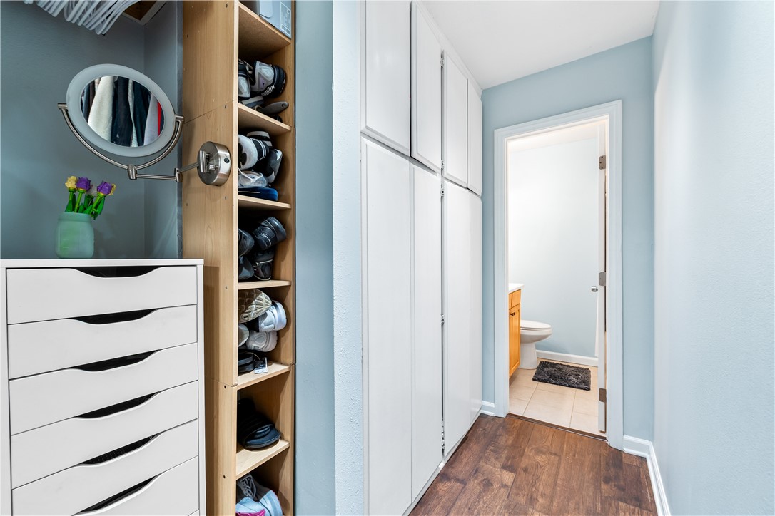 7890 East Spring Street, Unit 22F Long Beach, CA 90815 - Photo 17 of 35 a view of walk in closet with clothes and shoes