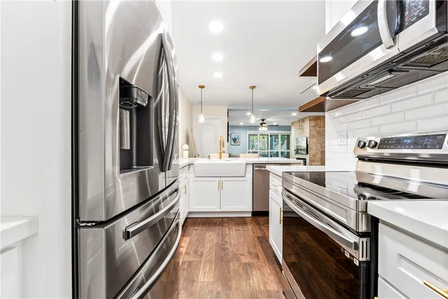 a kitchen with a refrigerator stove and microwave