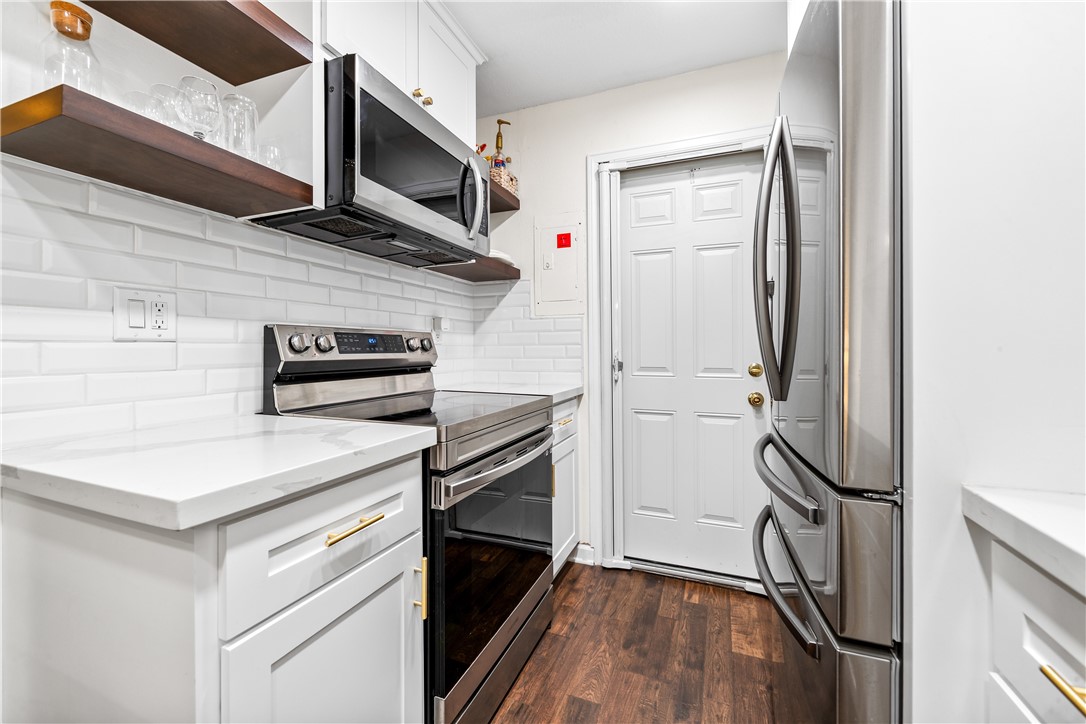 7890 East Spring Street, Unit 22F Long Beach, CA 90815 - Photo 18 of 60 a kitchen with a refrigerator stove and microwave