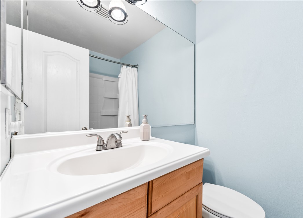 7890 East Spring Street, Unit 22F Long Beach, CA 90815 - Photo 19 of 35 a bathroom with a sink vanity mirror and toilet