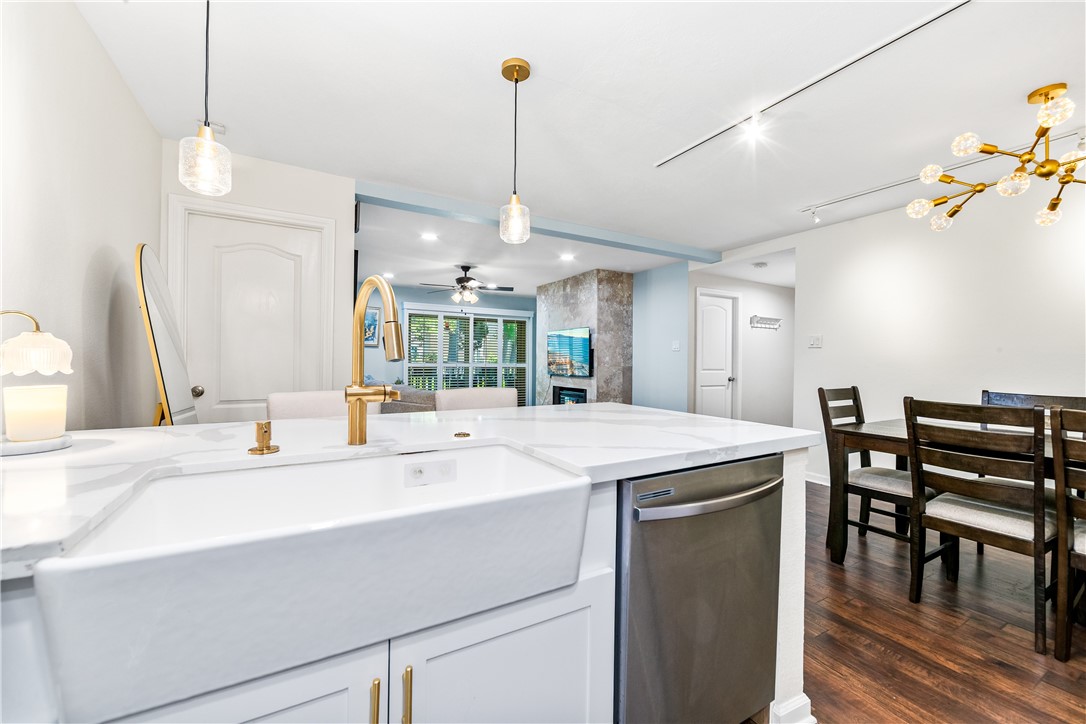 7890 East Spring Street, Unit 22F Long Beach, CA 90815 - Photo 2 of 35 a kitchen with a stove a refrigerator and a dining table