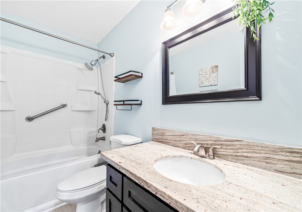 7890 East Spring Street, Unit 22F Long Beach, CA 90815 - Photo 23 of 35 a bathroom with a granite countertop sink toilet and a bathtub