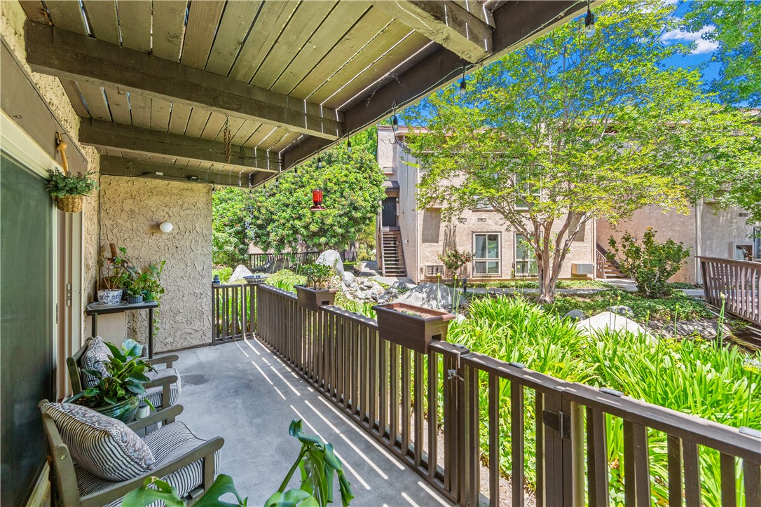 7890 East Spring Street, Unit 22F Long Beach, CA 90815 - Photo 28 of 60 a view of a patio with table and chairs and potted plants