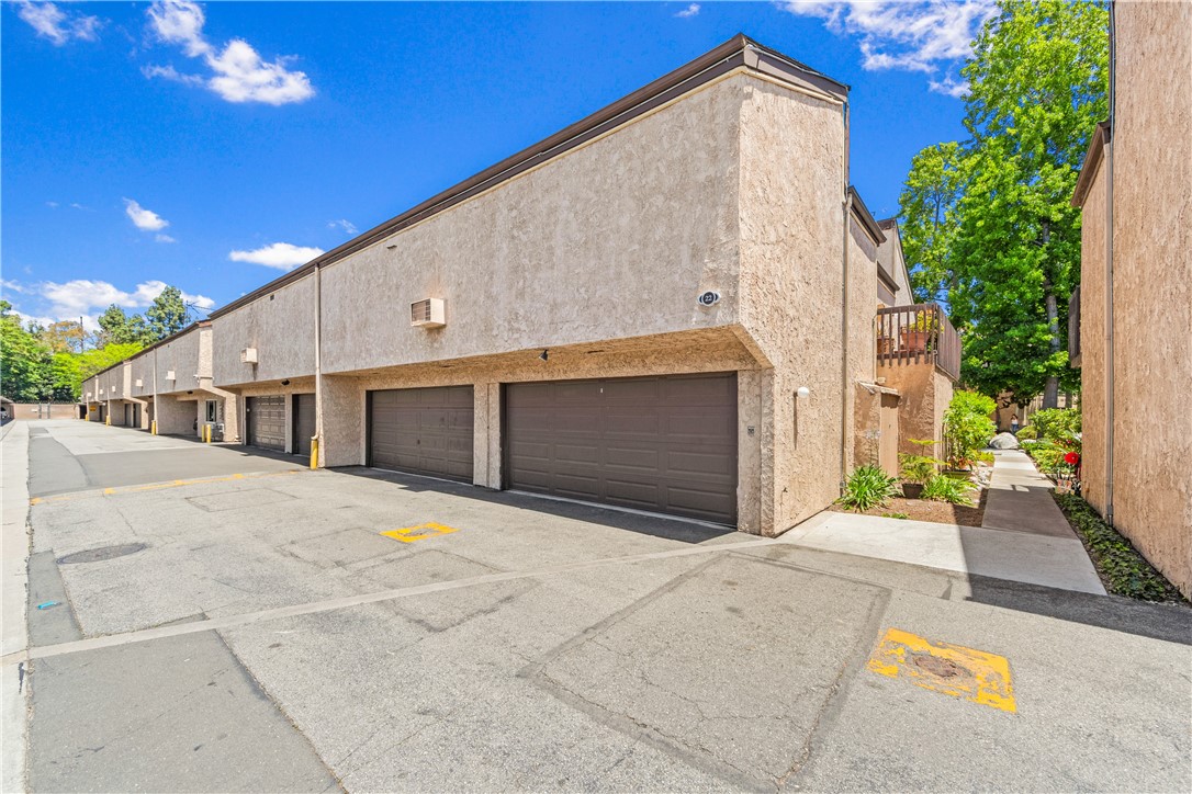 7890 East Spring Street, Unit 22F Long Beach, CA 90815 - Photo 31 of 35 a front view of a house with a garage