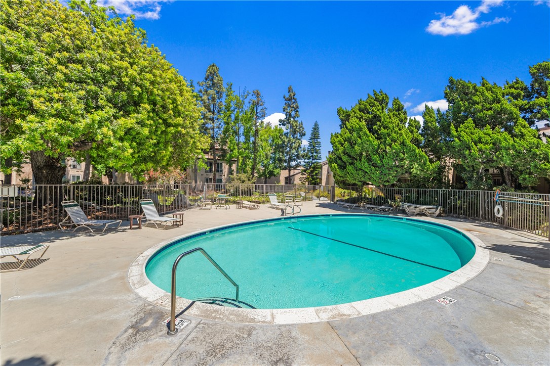 7890 East Spring Street, Unit 22F Long Beach, CA 90815 - Photo 35 of 35 a view of a swimming pool in the backyard of house
